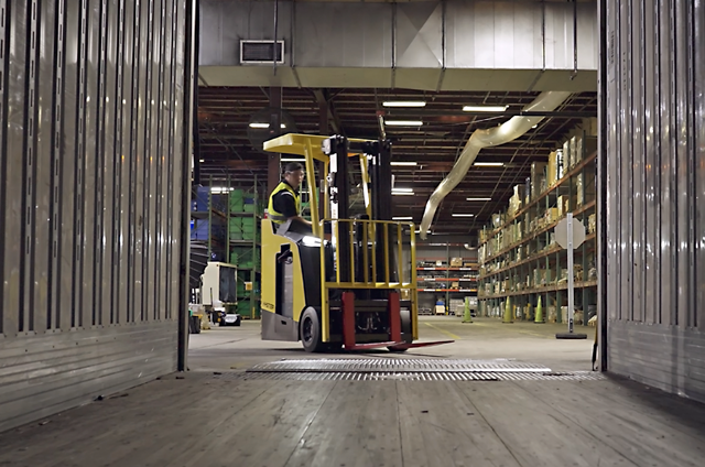 A forklift operator drives a Hyster three-wheel stand